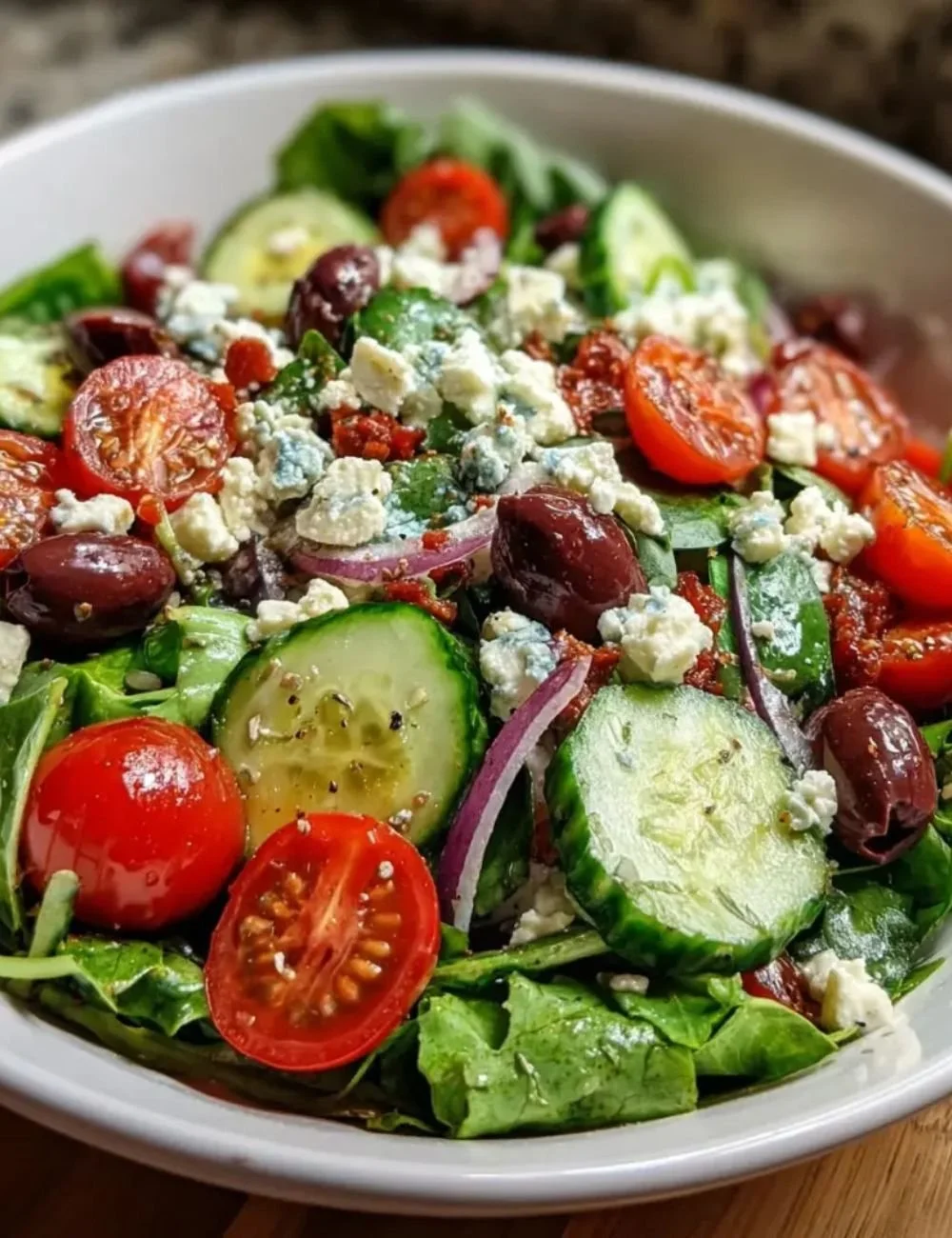 Mediterranean green salad bowl with fresh vegetables and herbs