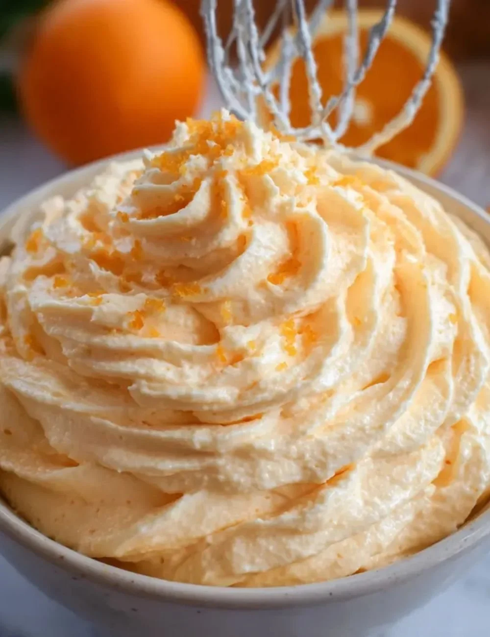 Delicious orange creamsicle buttercream frosting on a cupcake.
