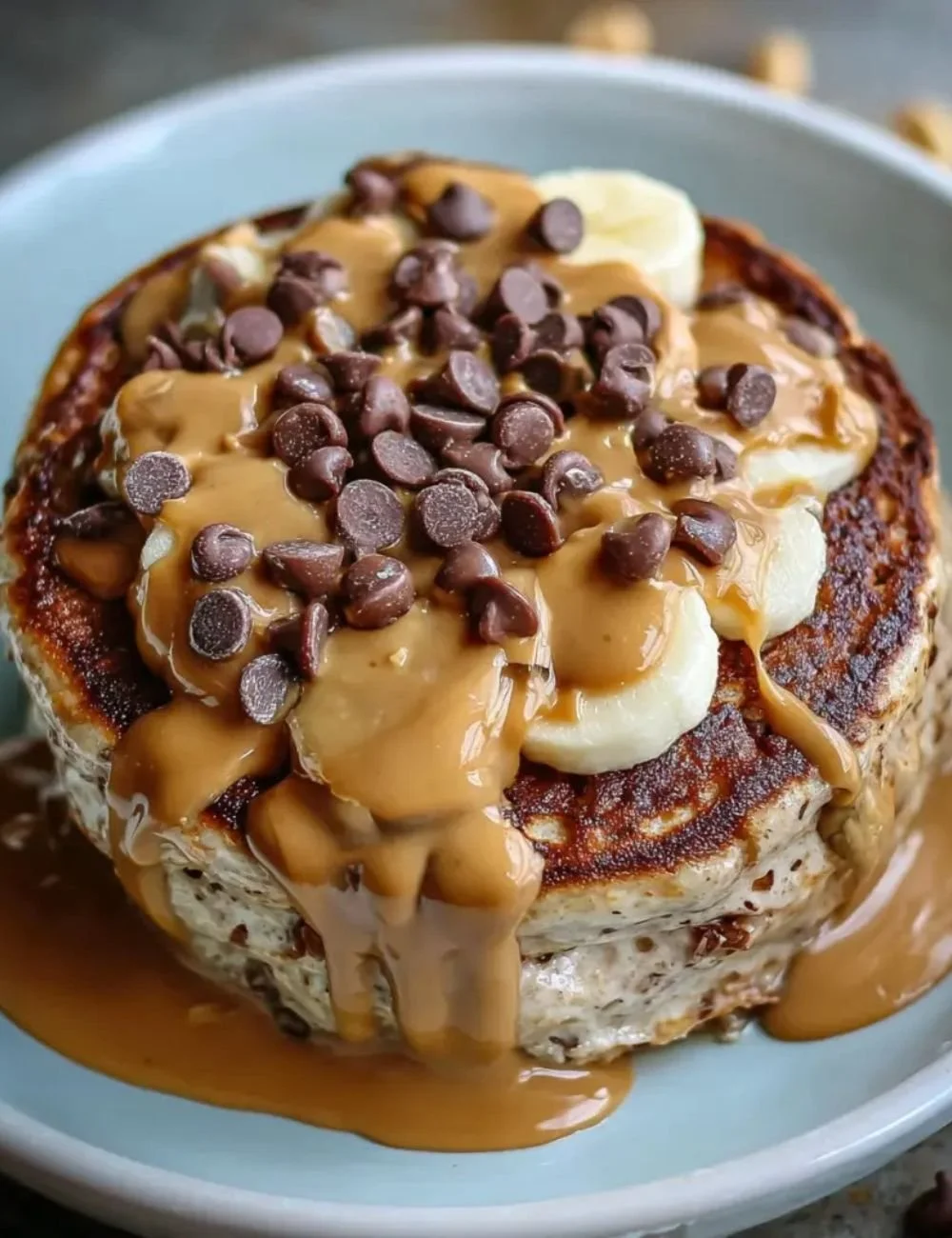 Delicious Peanut Butter Cup Protein Pancake Bowl topped with chocolate and peanuts