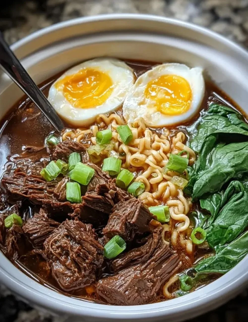 Bowl of slow cooker beef ramen noodles with fresh toppings and herbs