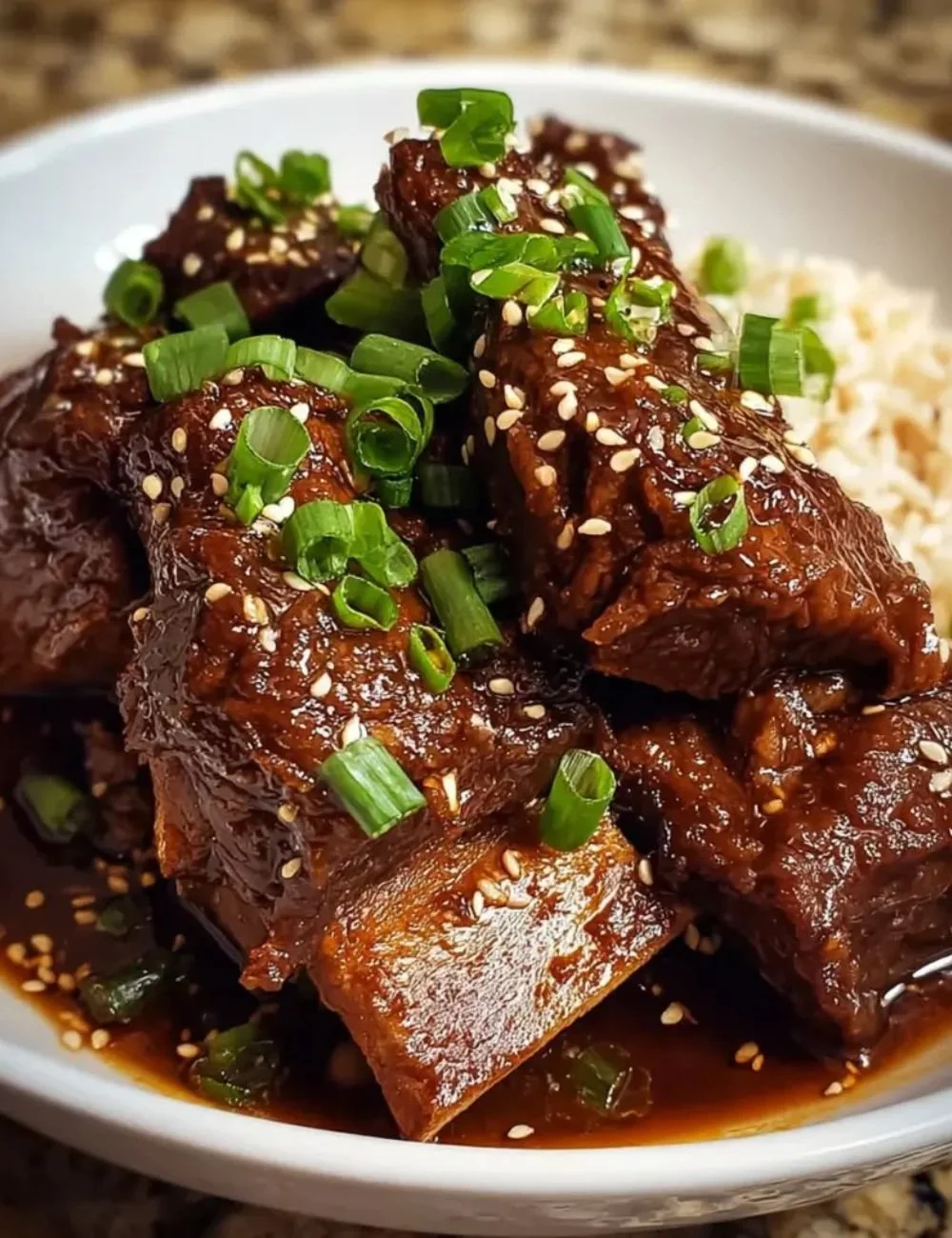 Delicious slow cooker Korean short ribs in a savory sauce served with rice.