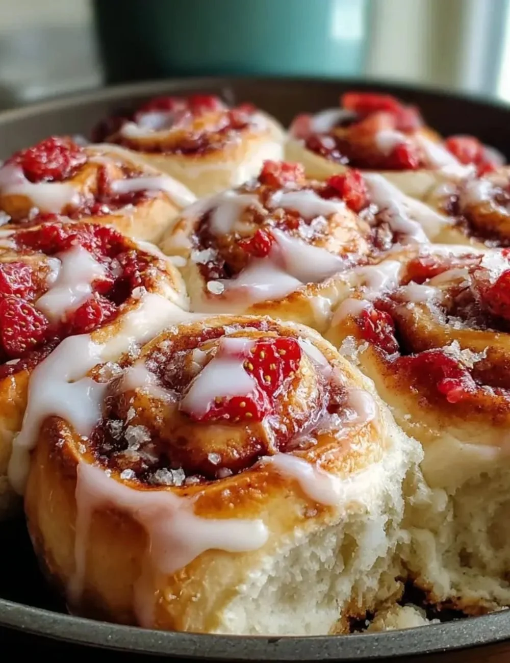 Freshly baked strawberry cinnamon rolls with brioche and cinnamon glaze