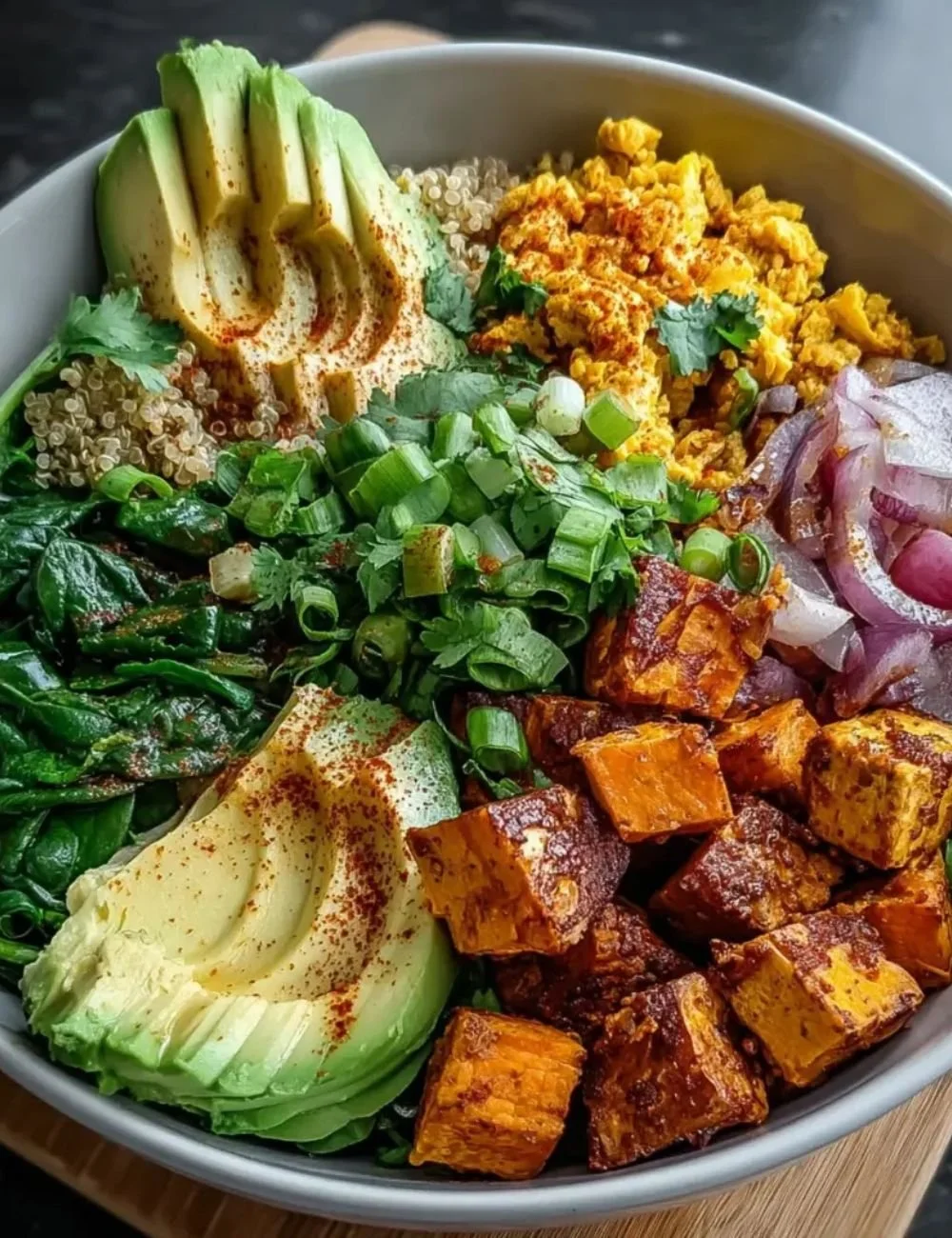 Tofu scramble vegan breakfast bowl with fresh vegetables and spices