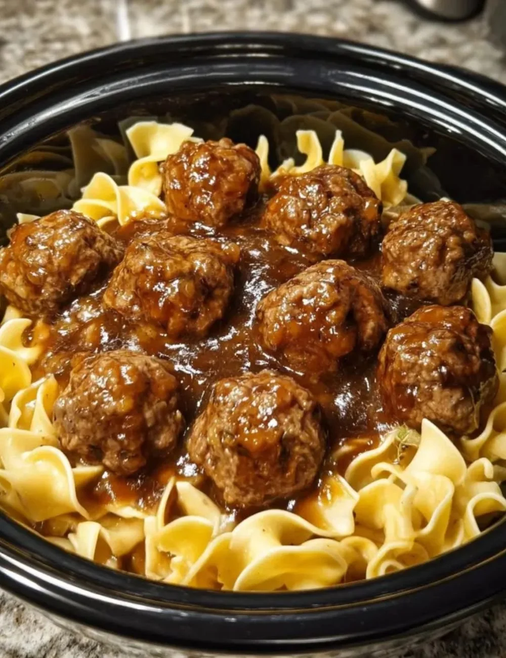 Delicious Amish meatball noodles served in a bowl, showcasing savory meatballs and noodles.