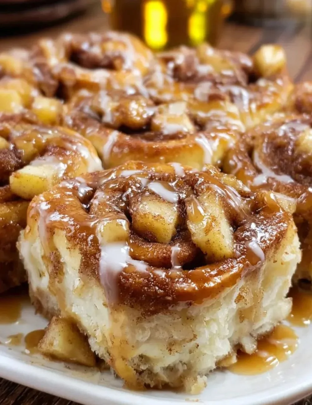Delicious Apple Pie Cinnamon Roll Bake topped with a caramel drizzle.