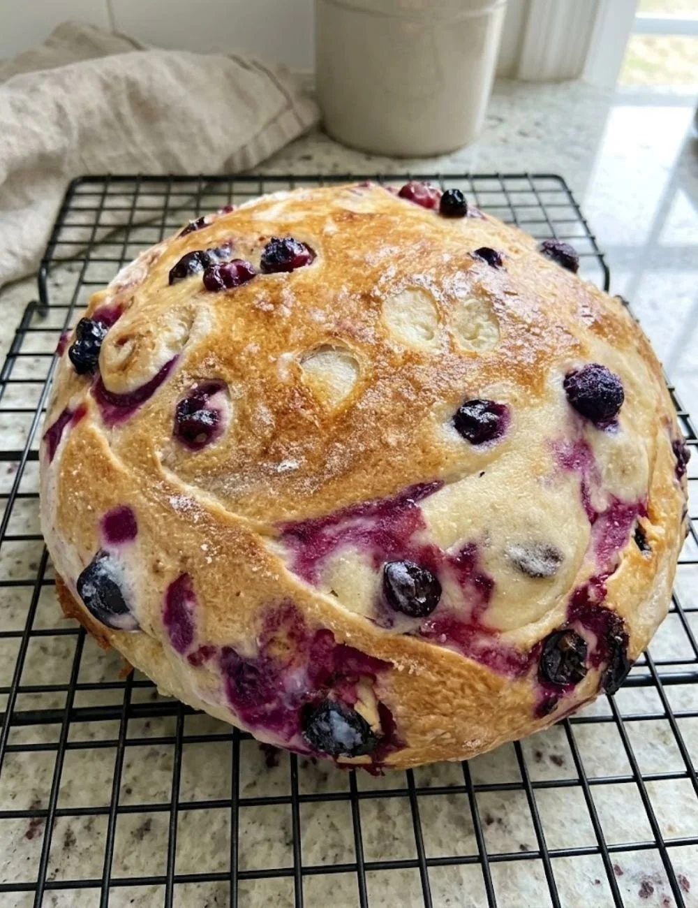 Sliced Blueberry Lemon Cream Cheese Sourdough Bread on a wooden board