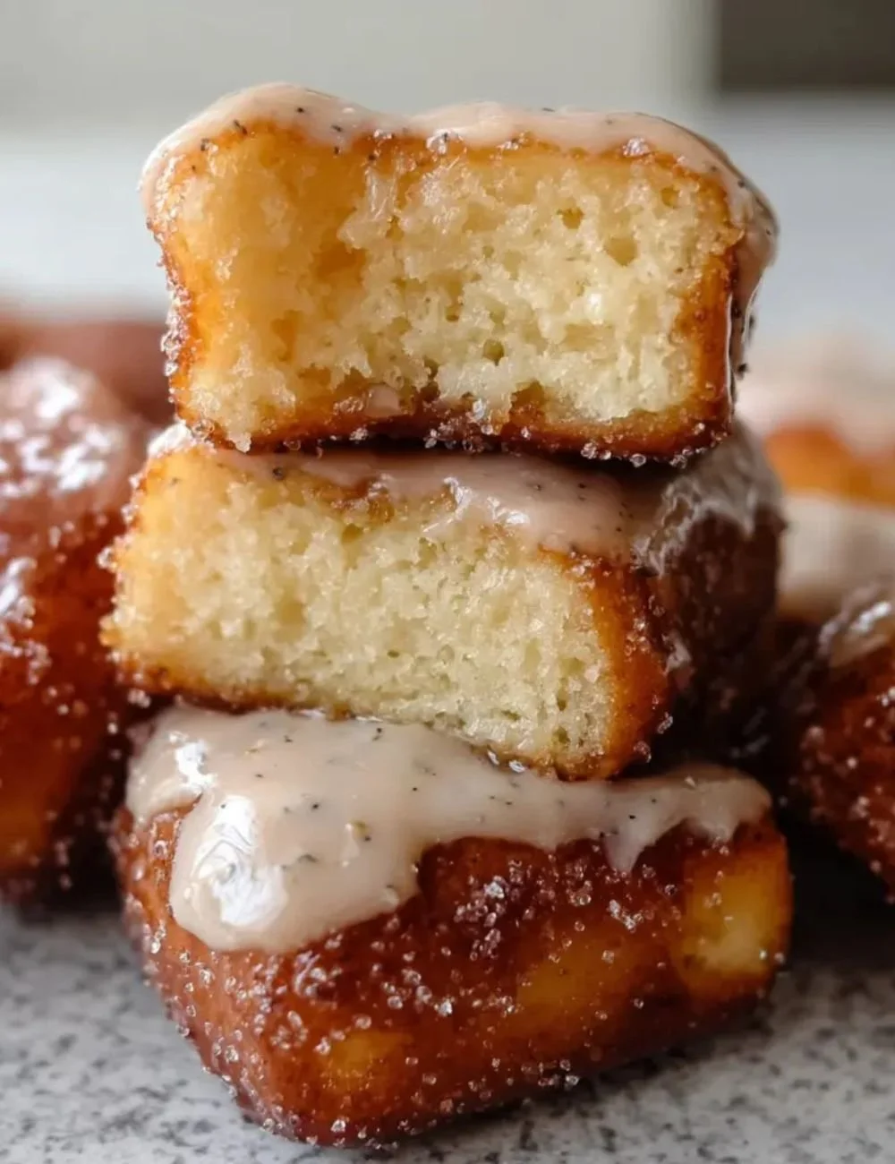 Brown butter maple donut bars served on a plate with a drizzle of maple glaze.