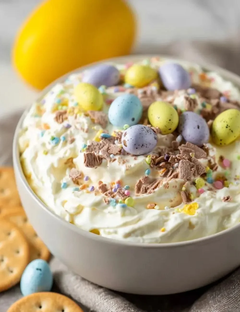 Delicious Cadbury Egg Dip served in a bowl with chocolate-covered fruit