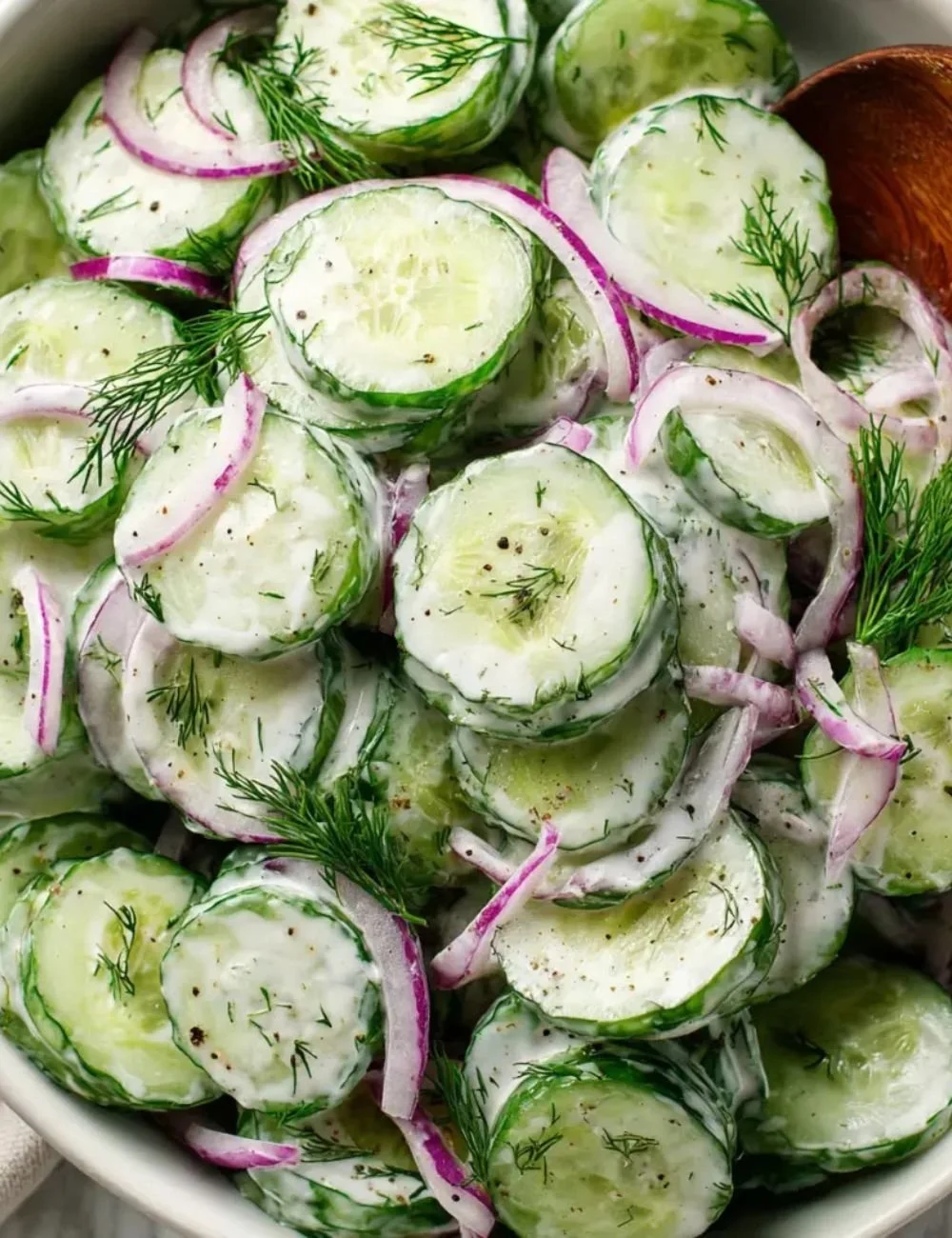 Dill Yogurt Cucumber Salad served in a bowl with fresh herbs