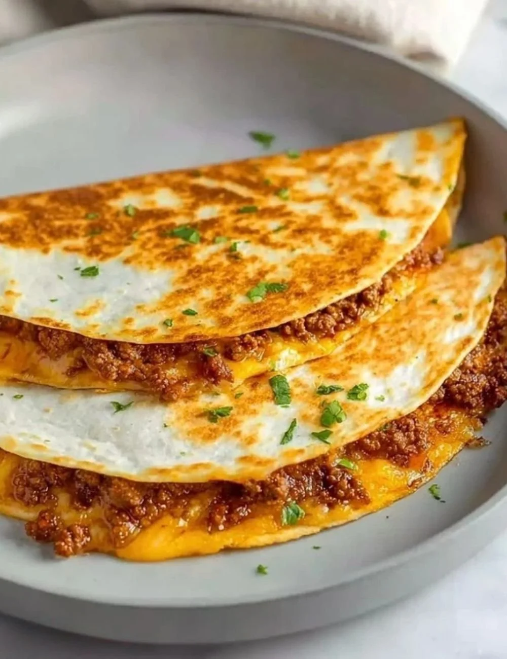 Delicious easy cheesy ground beef quesadillas on a plate
