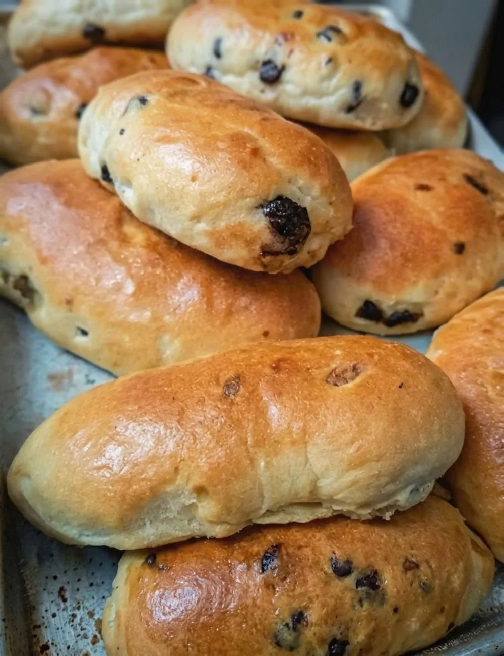 Homemade sourdough runzas filled with savory ingredients on a wooden table
