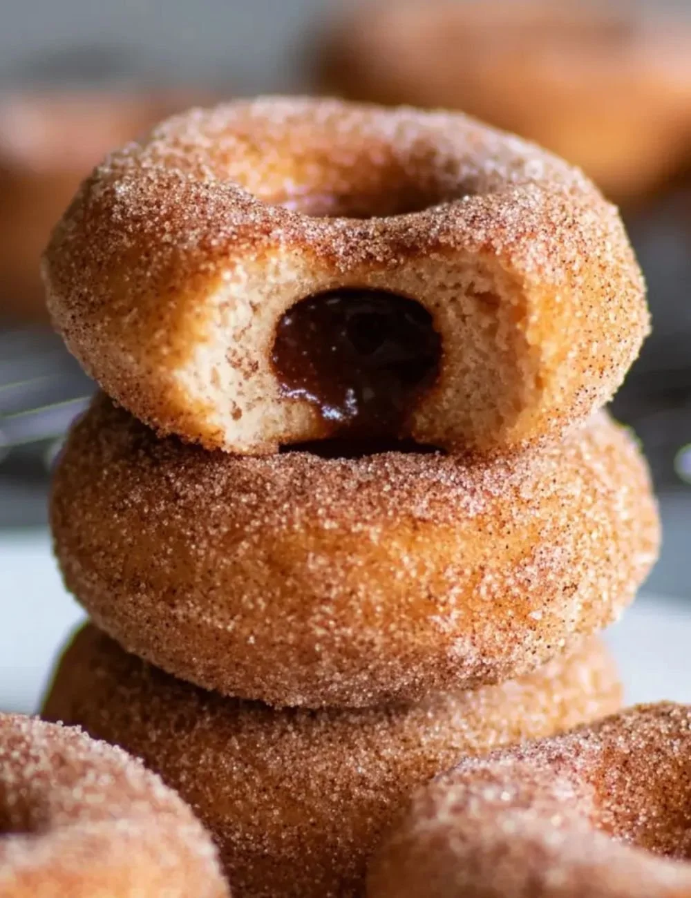 Keto cinnamon sugar donuts topped with a sugar-free sprinkle