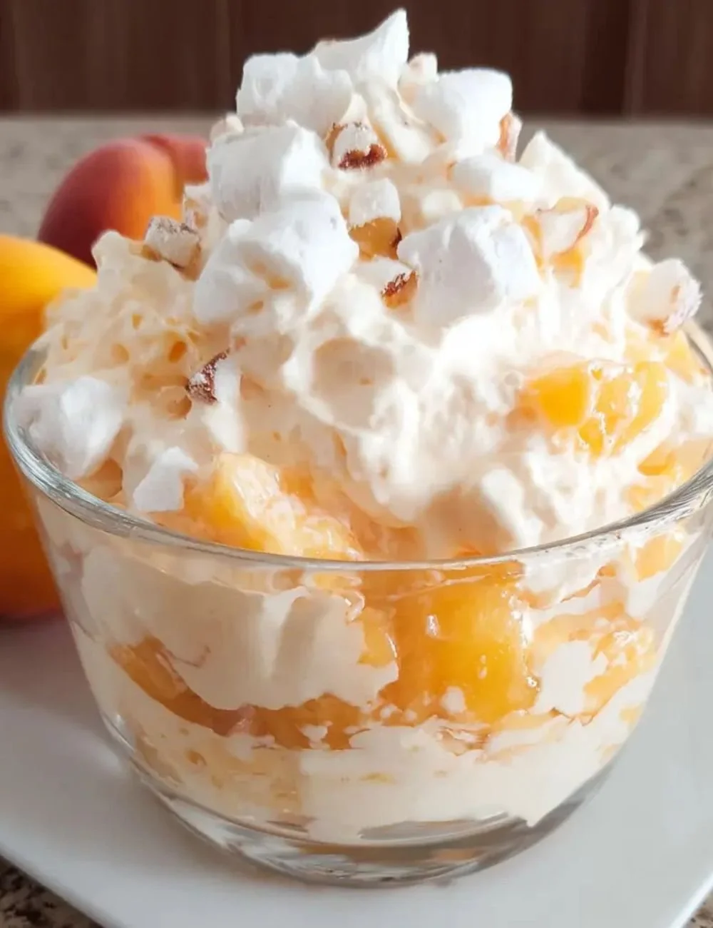 Delicious peach fluff dessert served in a bowl with fresh peaches