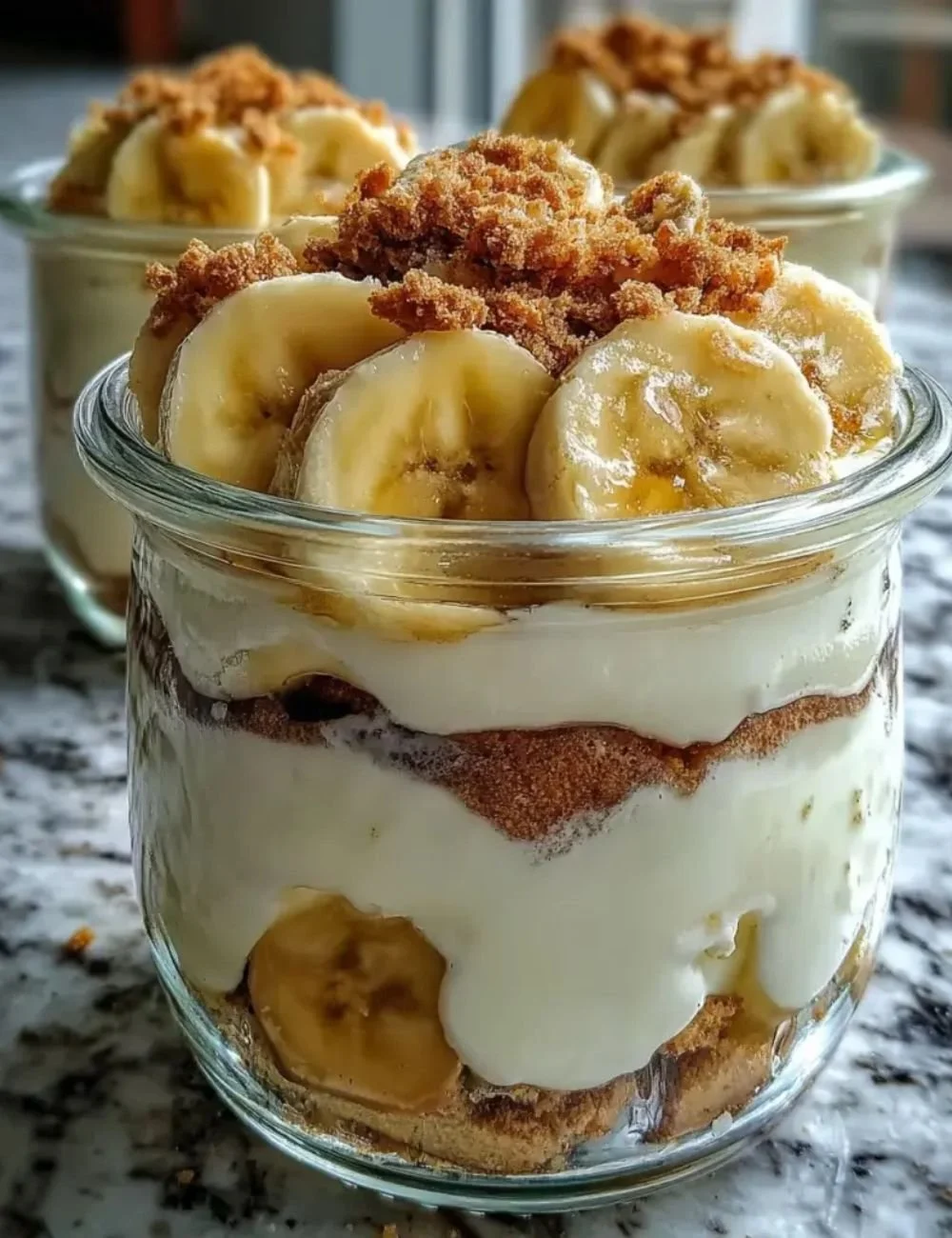 Bowl of Protein Banana Pudding topped with banana slices and nuts
