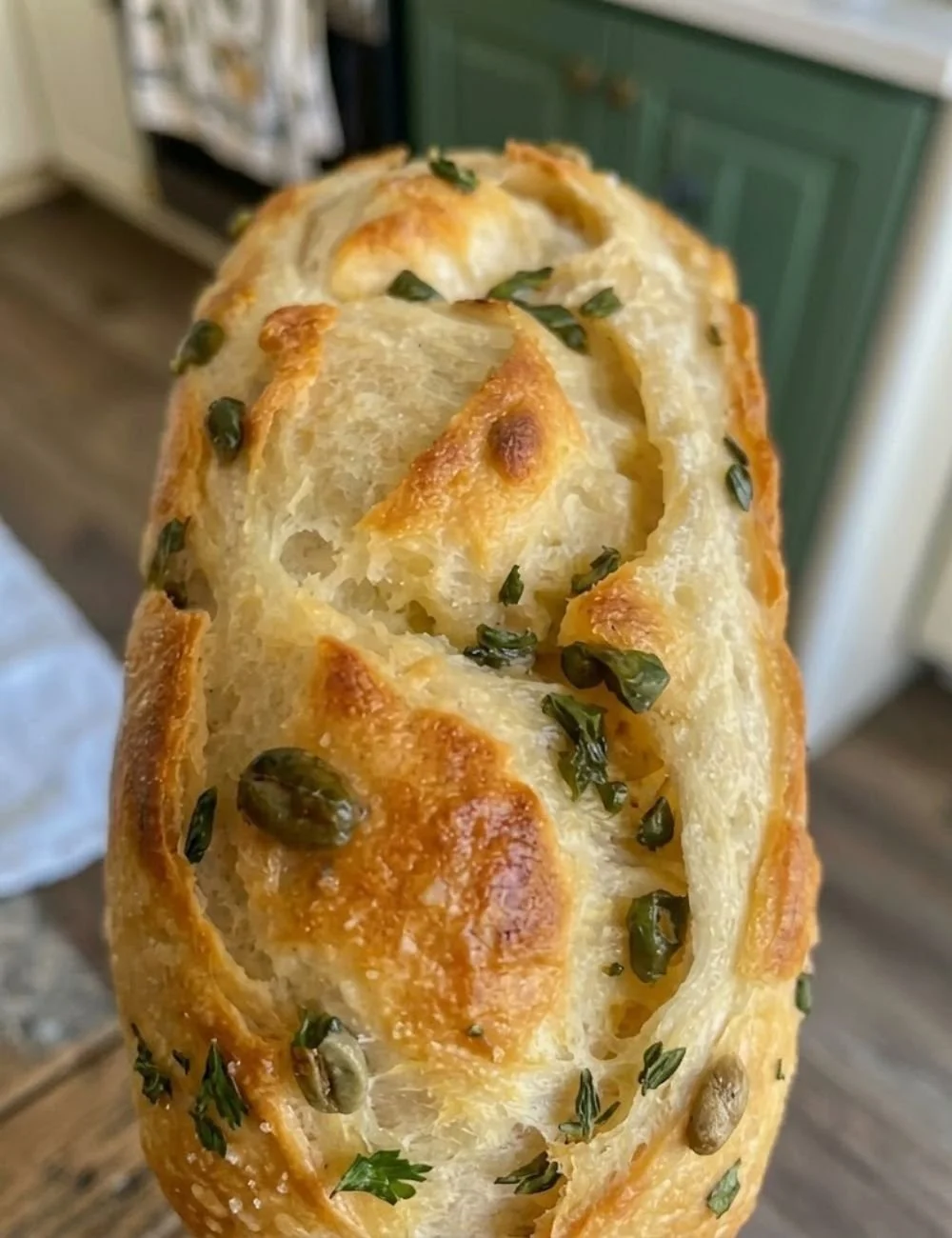 Soft and crunchy sourdough loaf with olive oil and egg, fresh from the oven.