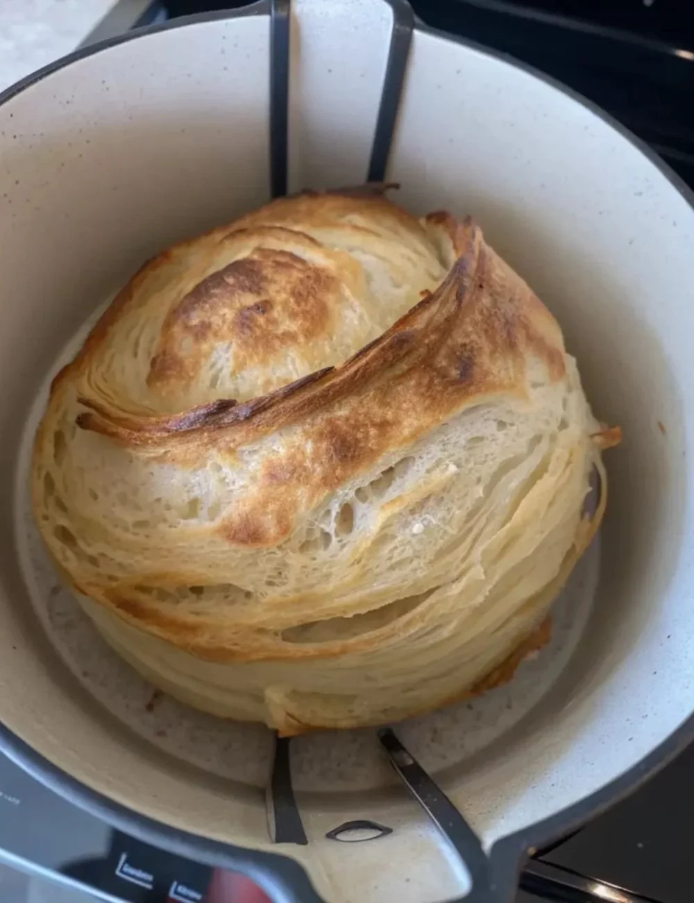 Freshly baked sourdough croissants on a wooden table
