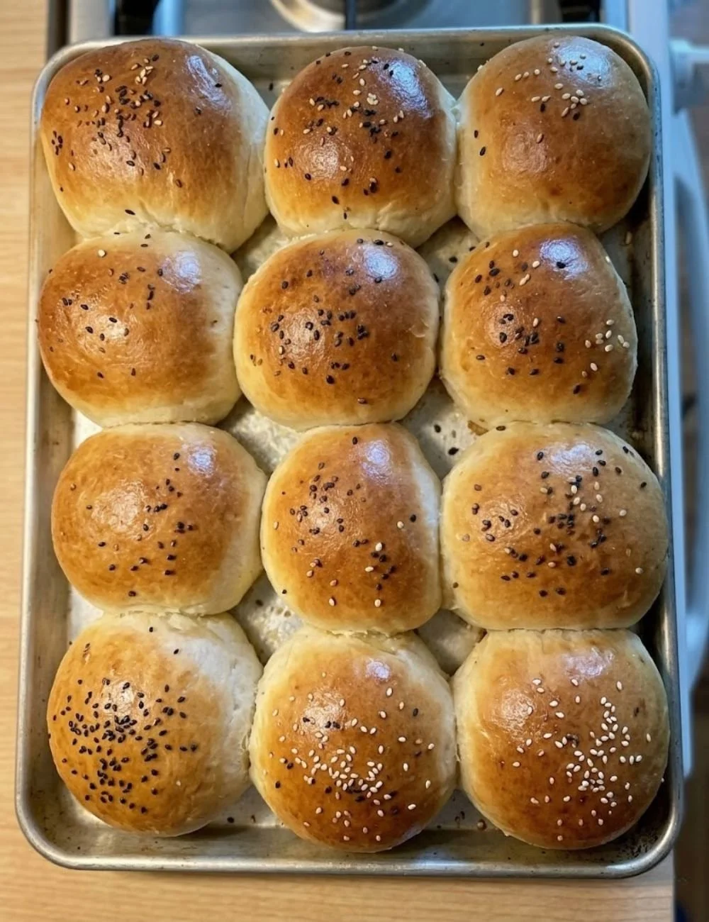 One-hour sourdough discard hamburger buns on a wooden table