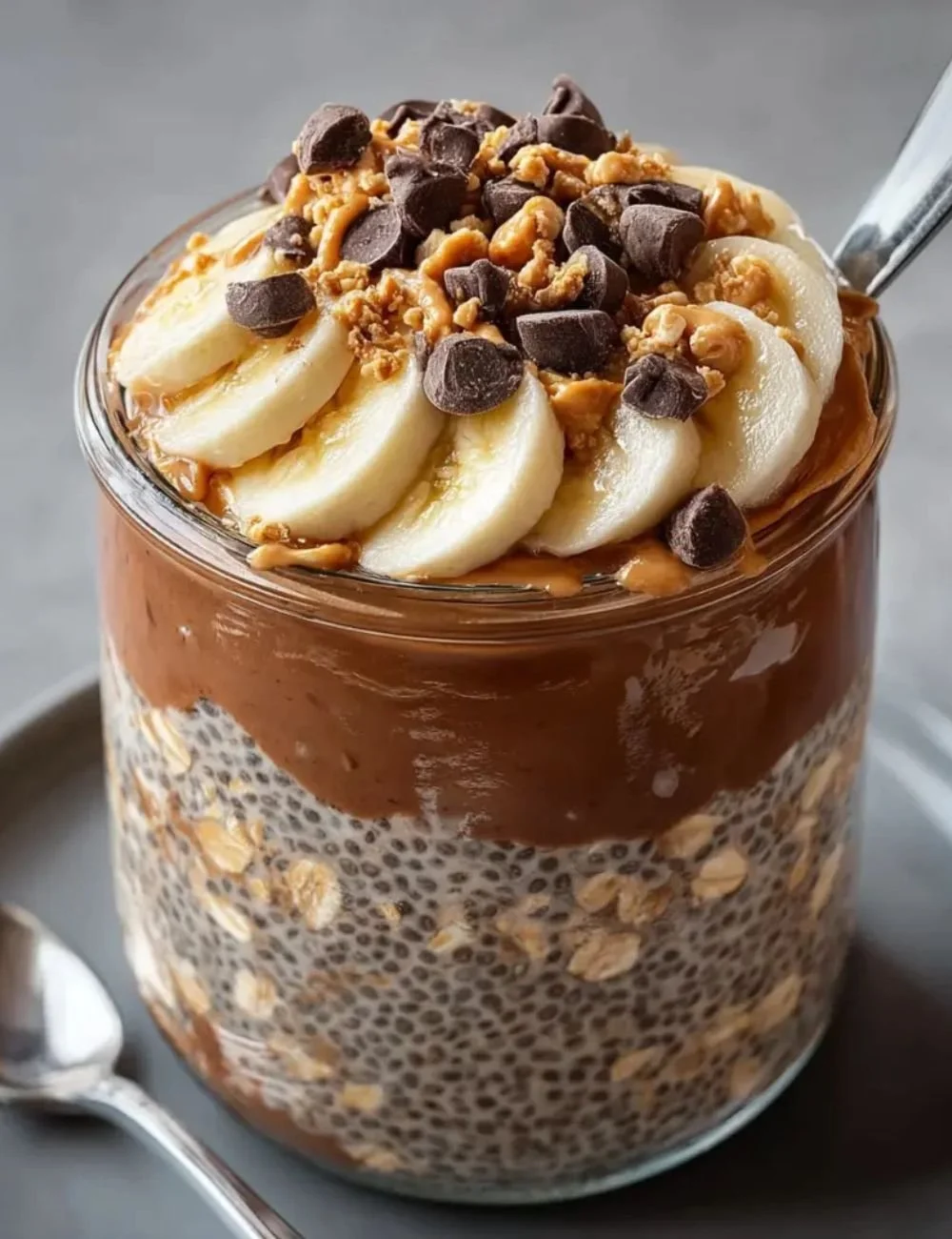 Delicious chocolate peanut butter overnight oats topped with sliced bananas