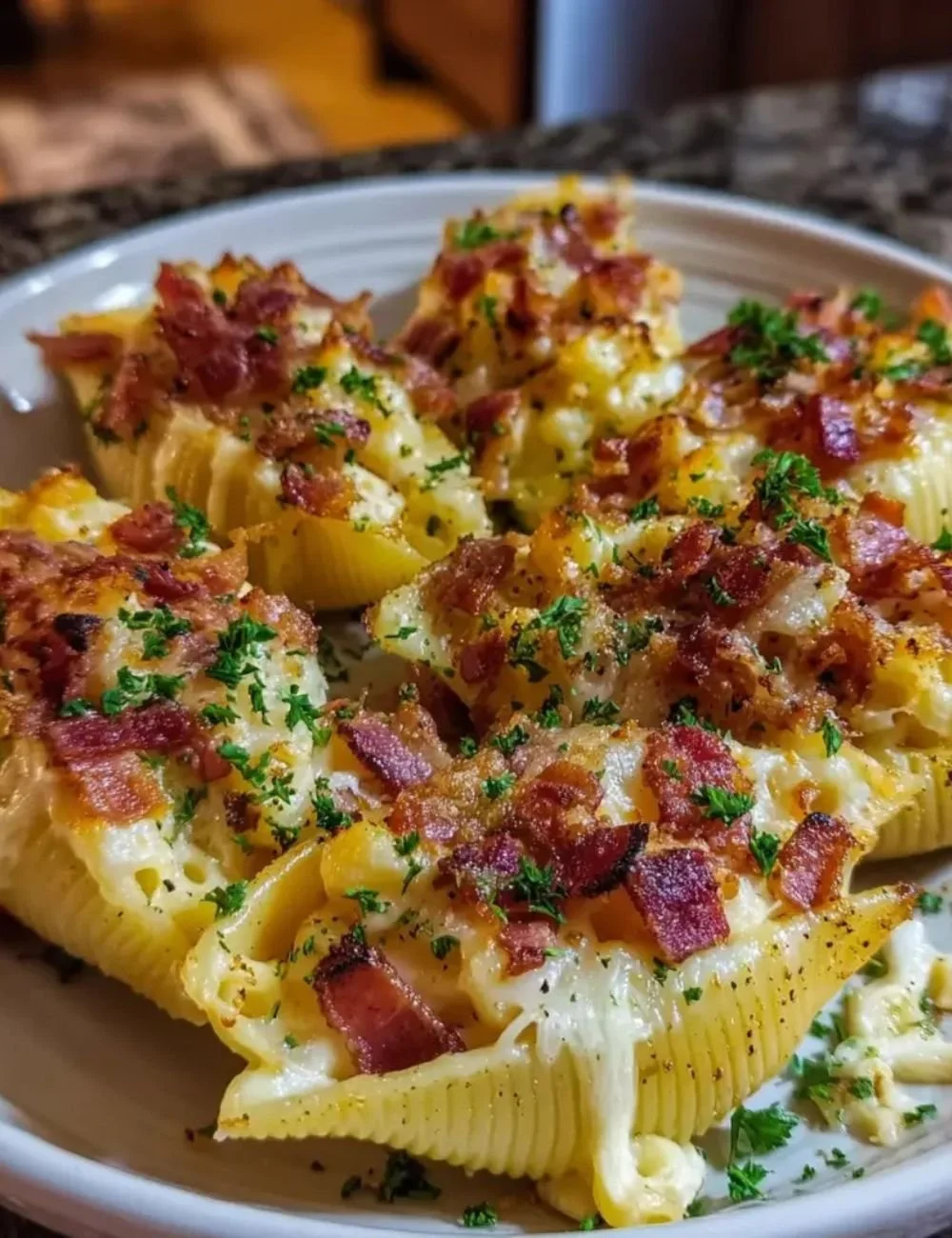 Creamy loaded bacon mac and cheese stuffed shells on a plate